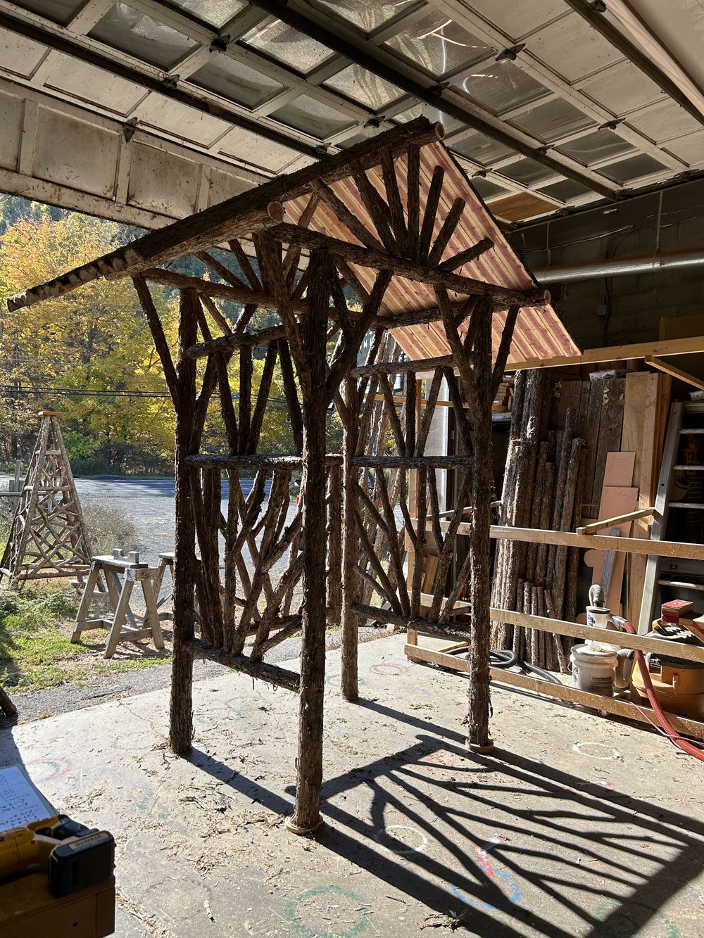 Natural wood rustic arbor built with trees and branches titled theDempsey Arbor and Gate