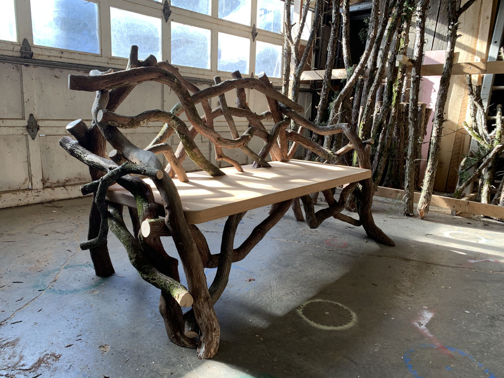 Outdoor rustic park bench built using mountain laurel trees and branches titled the Mountain Laurel Bench