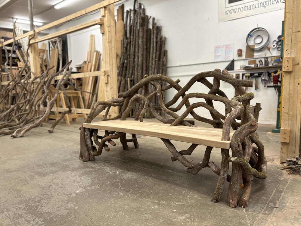 Outdoor rustic park bench built using mountain laurel trees and branches titled the Concord Laurel Bench