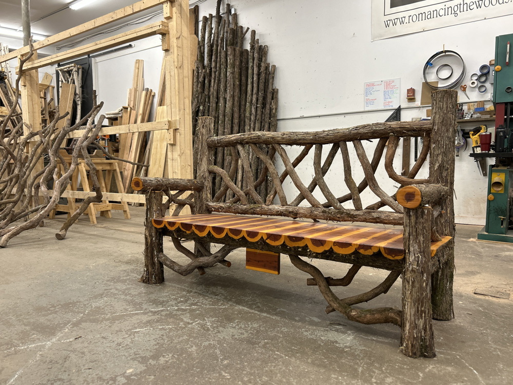Outdoor park bench built in the rustic style using logs and branches titled the Mohonk Putnam Bench