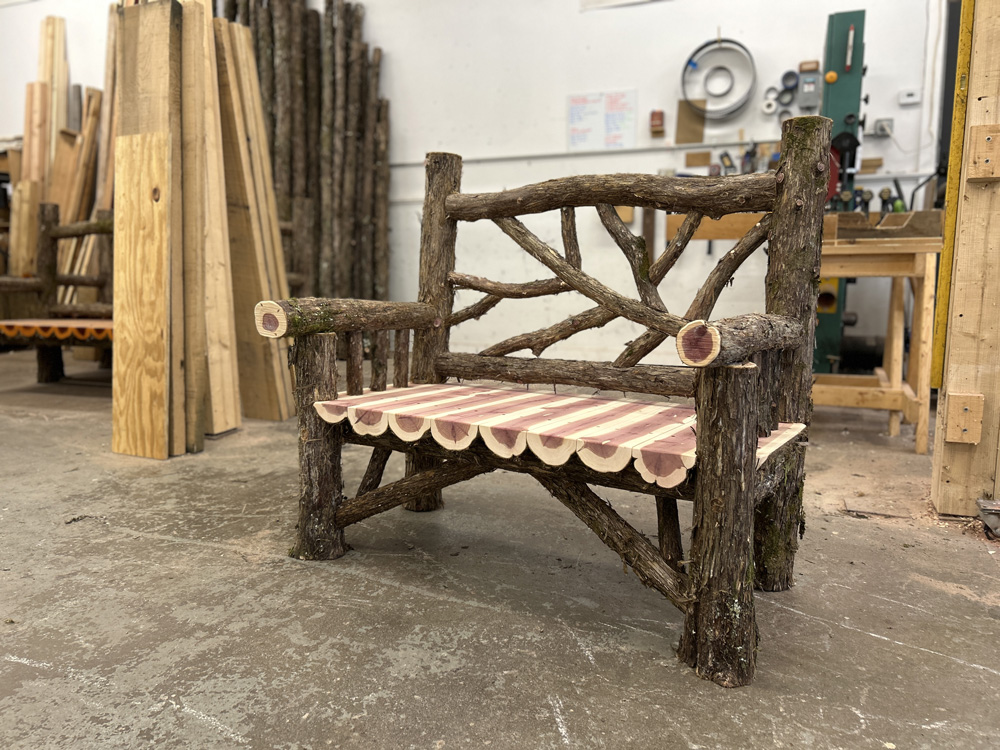 Rustic bench custom built using cedar trees and branches titled the Rhinecliff Bench