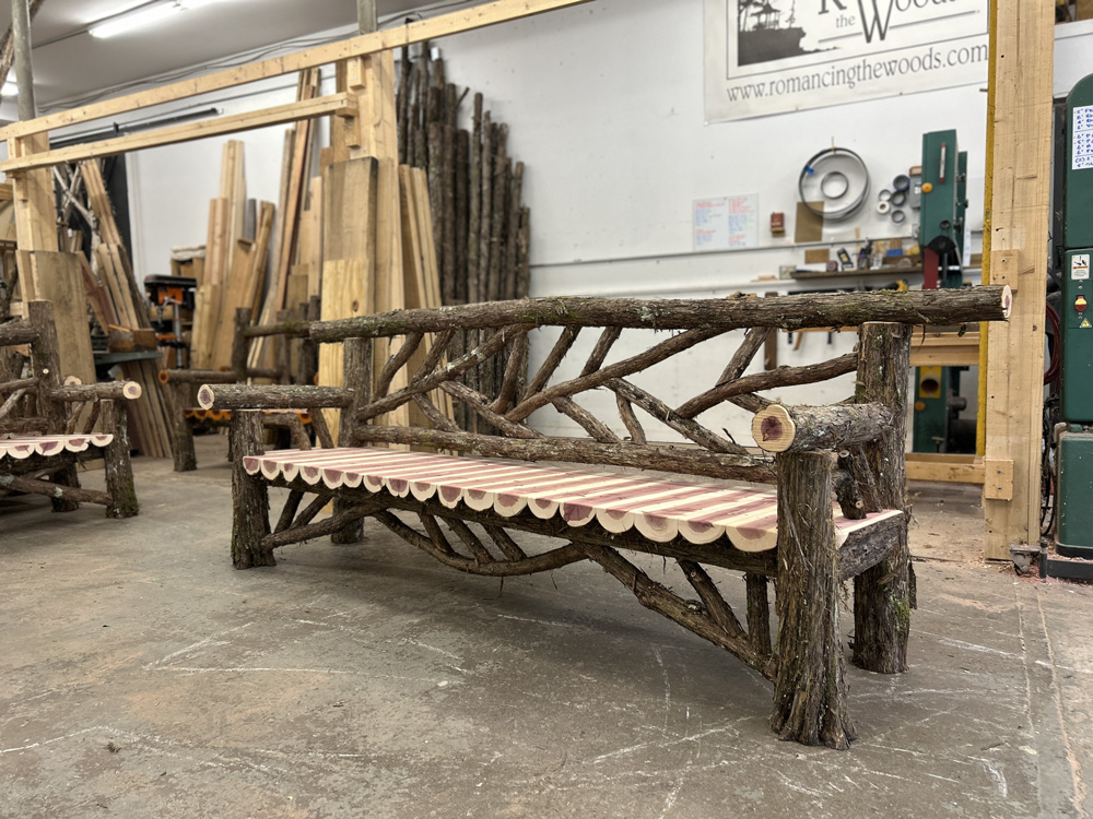 Natural wood bench built with trees and branches titled the Rhinecliff Bench
