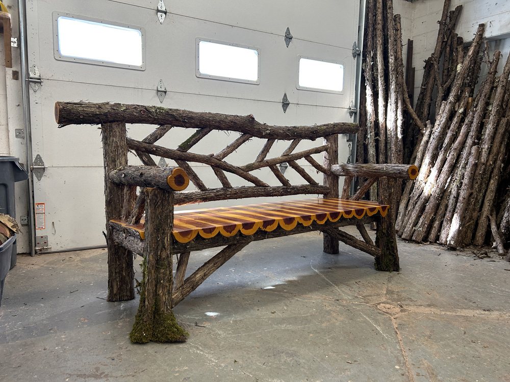 Outdoor rustic garden bench built using bark-on trees and branches titled the Rhinebeck Bench