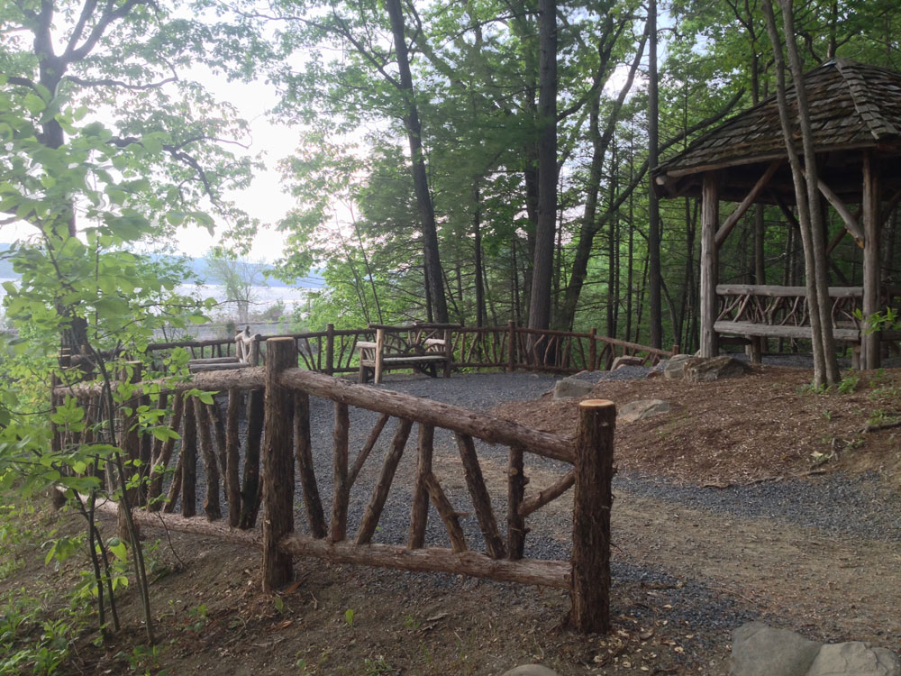 Natural wood fencing built with trees and branches installed at Poet's Walk Park