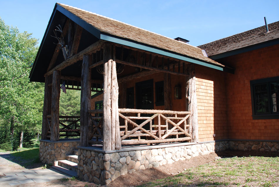 Rustic railings built using bark-on trees and branches titled the Bearsville Railings