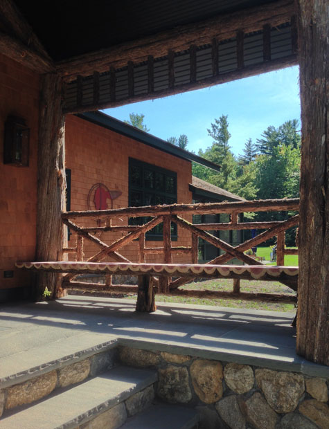 Rustic railings built using bark-on trees and branches titled the Bearsville Benches