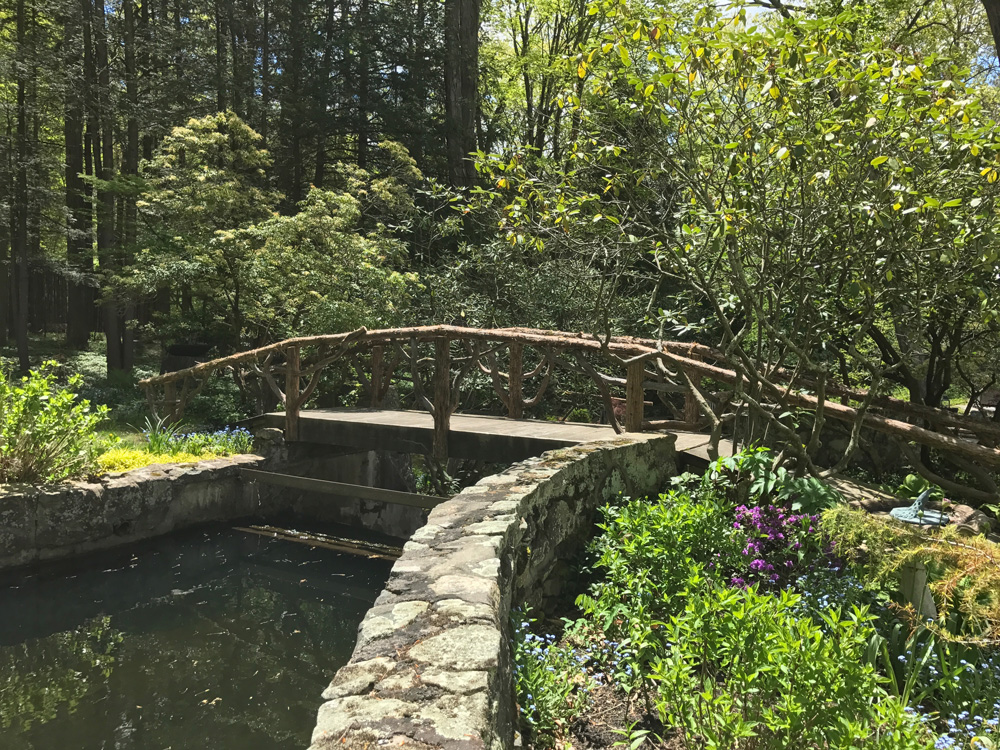 Bridge built in the rustic style using logs and branches titled the Milltown Bridge's