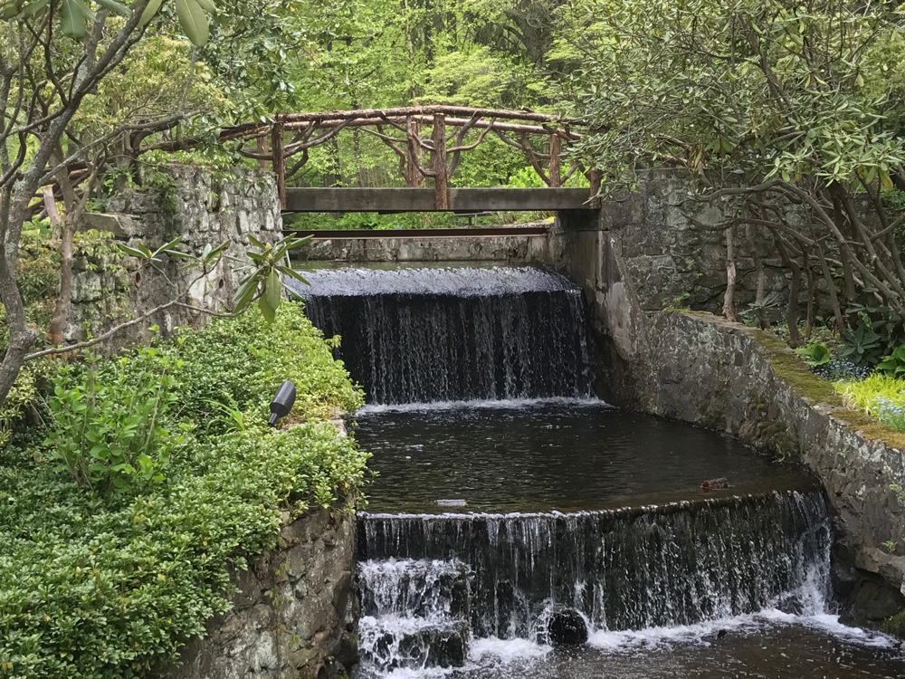 Bridge built in the rustic style using logs and branches titled the Milltown Bridge's