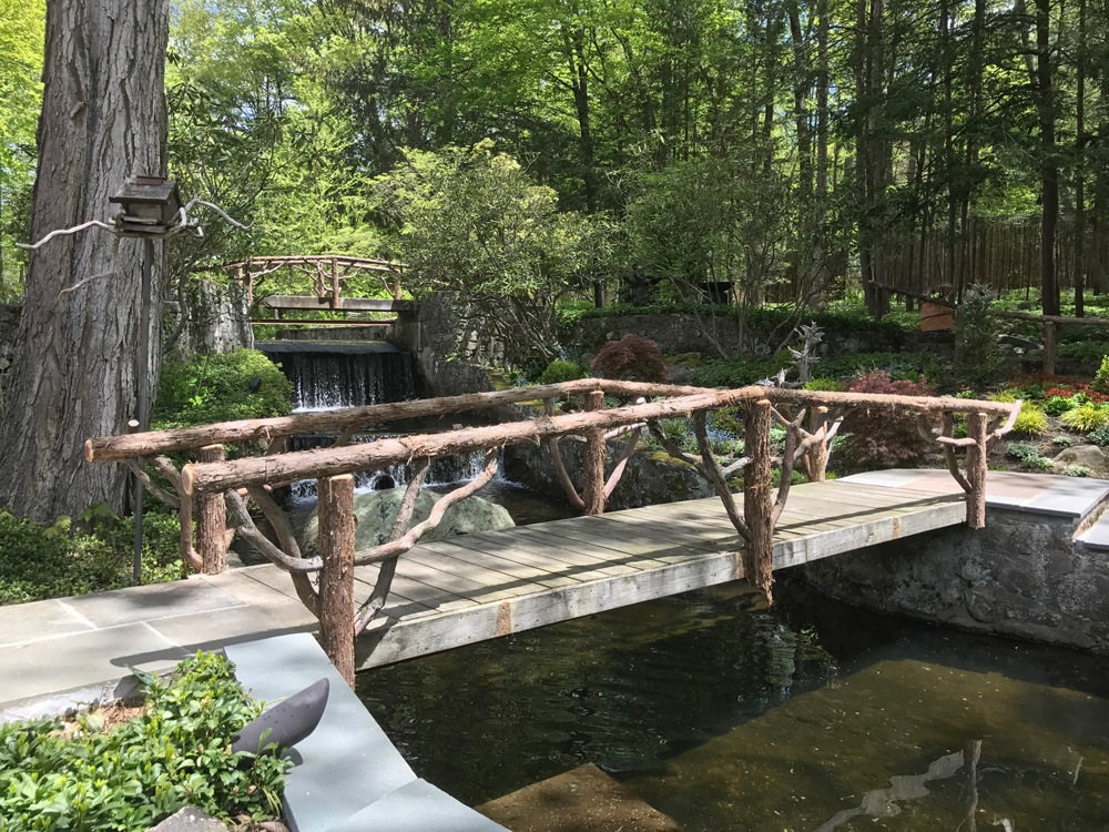 Bridge built in the rustic style using logs and branches titled the Milltown Bridge's