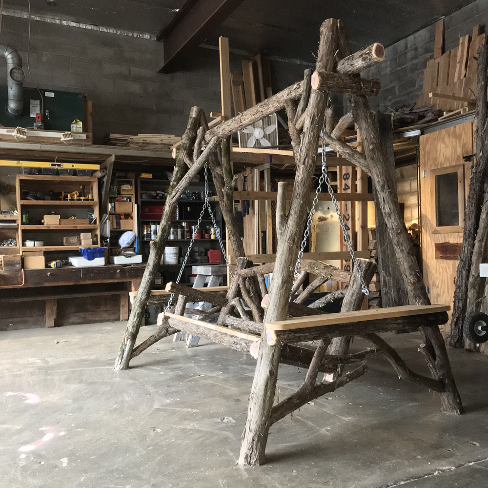 Outdoor rustic garden bench swing built using bark-on trees and branches titled the Bethany Bench Swing