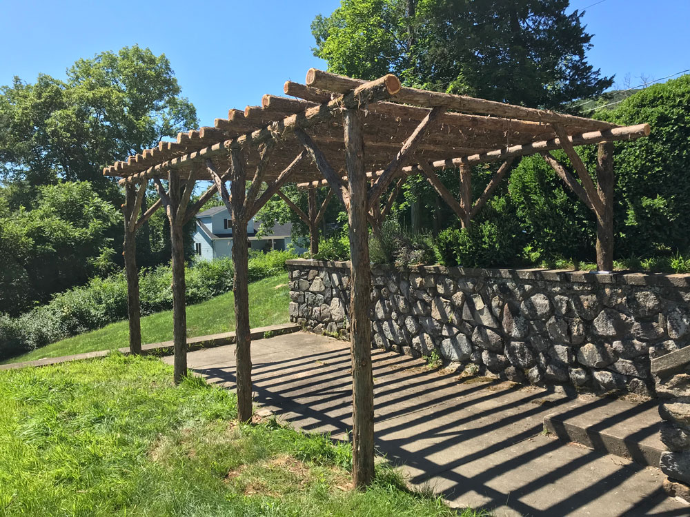 Branchwork rustic pergola constructed using natural materials titled the Wildwood Pergola