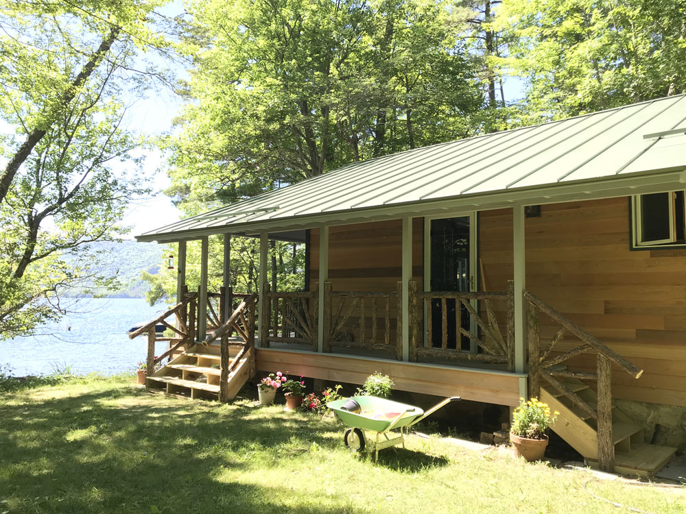 Rustic railings custom built using cedar trees and branches titled the Porch Railings at Hullets Landing