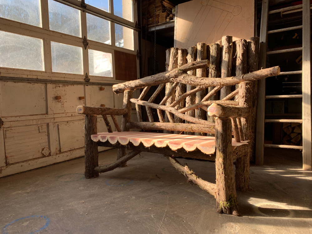 Natural wood bench built with trees and branches titled the 5' Rhinebeck Bench