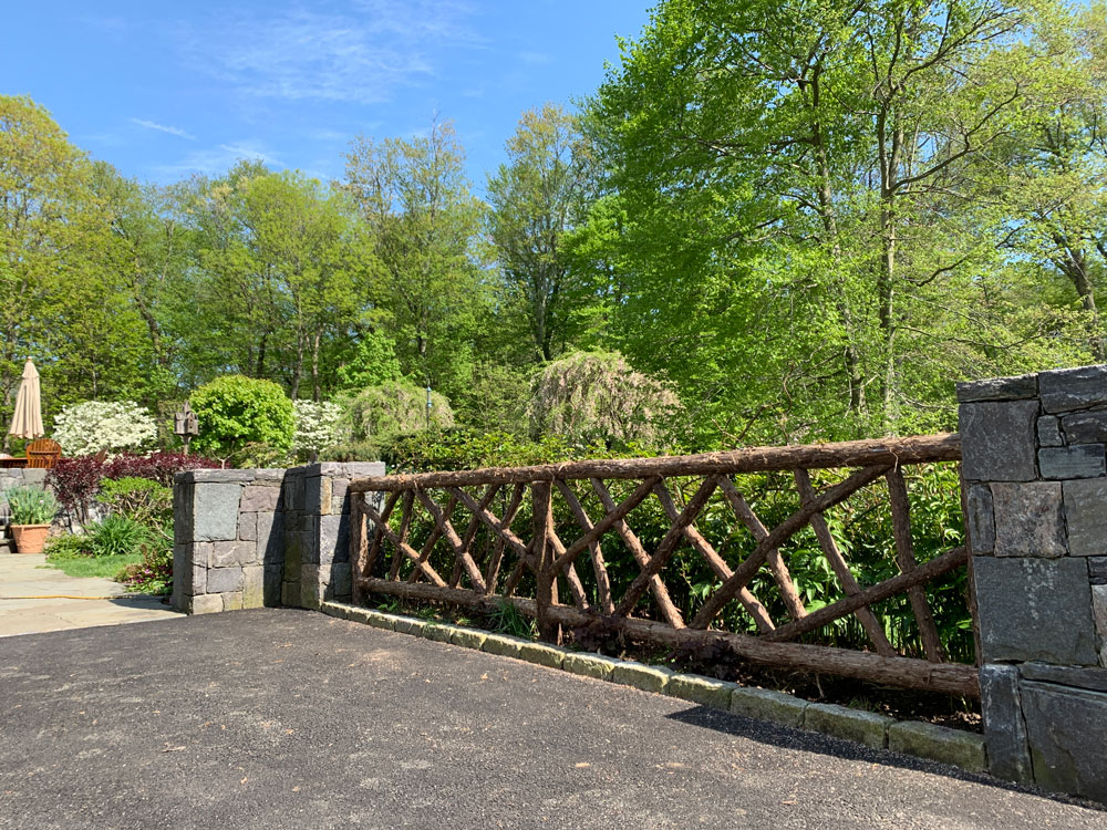 Fencing built in the rustic style using logs and branches titled the Ossining Fencing