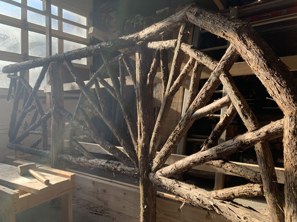 Rustic bridge railings built using bark-on trees and branches installed at Kirkside Park in Roxbury NY