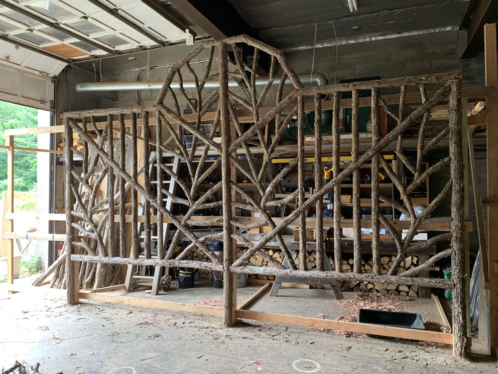 Rustic garden trellis built using bark-on trees and branches titled the Villanova Trellis