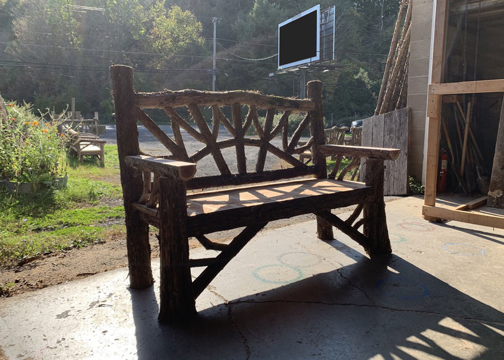 Exterior twig bench built from cedar logs titled the Maverick Bench