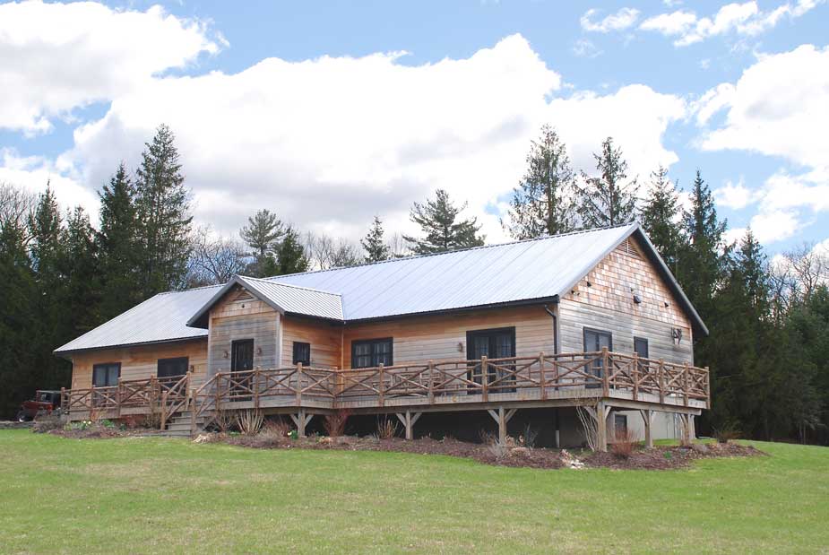 Rustic railings custom built using cedar trees and branches titled the Huguenot Deck Railings