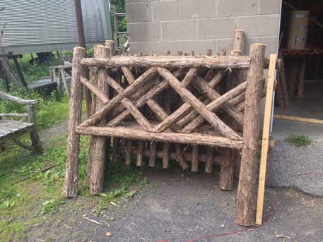 Rustic fencing custom built using cedar trees and branches titled the Old Chatham Fencing