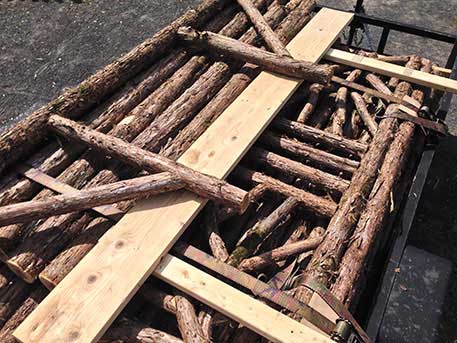 Rustic dining pavilion built in the rustic style using logs and branches titled the Martin Pavilion