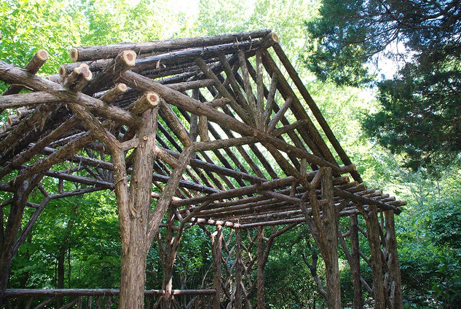 Rustic dining pavilion built in the rustic style using logs and branches titled the Martin Pavilion