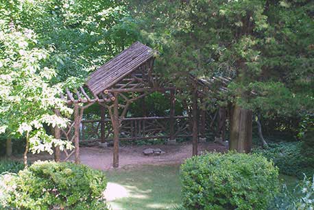 Rustic dining pavilion built in the rustic style using logs and branches titled the Martin Pavilion