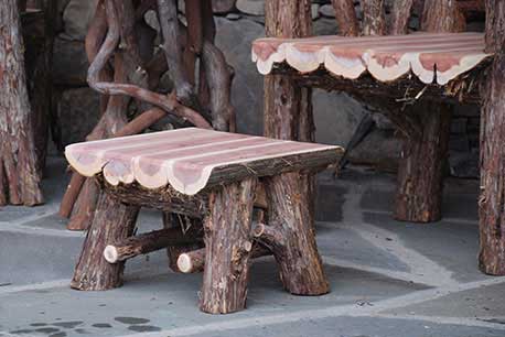 Rustic chair custom built using cedar trees and branches titled the Windham Chairs, Ottomans and Table