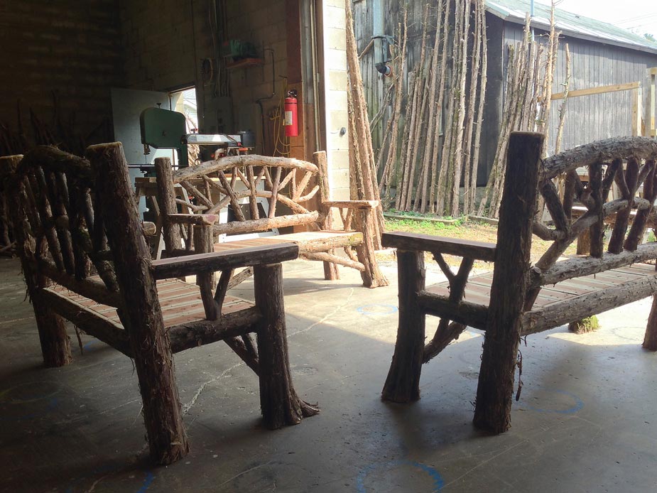 Rustic bench custom built using cedar trees and branches titled the Maverick Bench