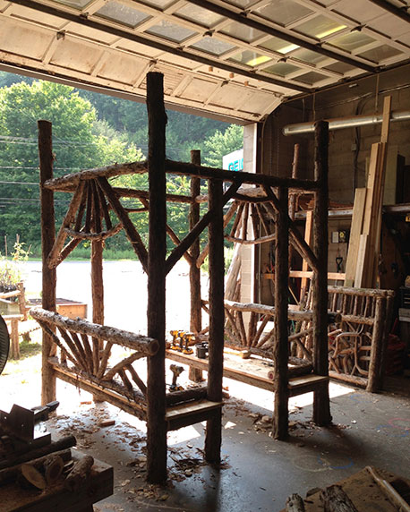 Rustic garden pavilion built using bark-on trees and branches titled the Briarcliffe Shelter