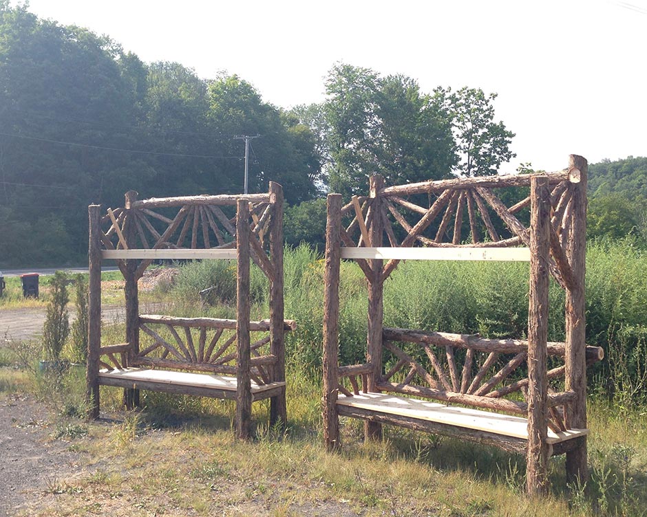 Rustic garden pavilion built using bark-on trees and branches titled the Briarcliffe Shelter