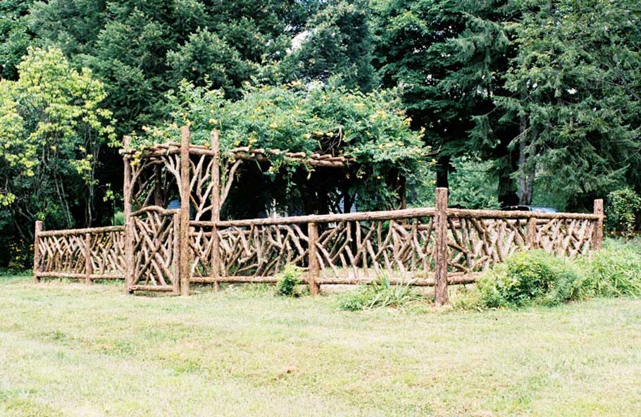 Rustic garden pergola and fencing built using bark-on trees and branches titled the Chiu Garden