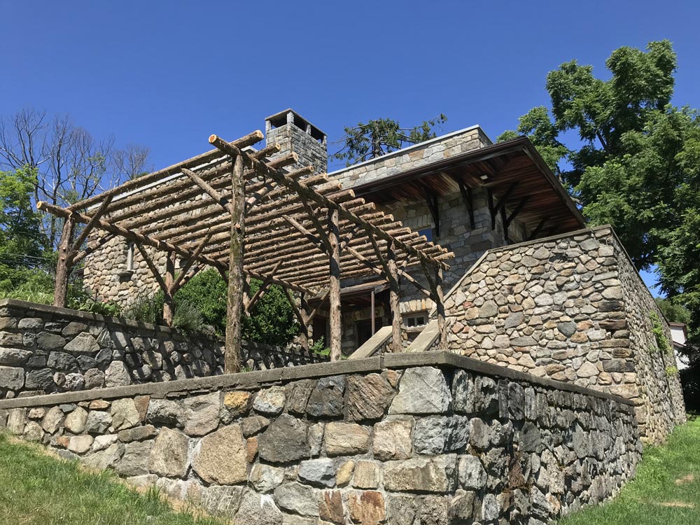 Natural wood rustic pergola built with trees and branches titled the Montgomery Pergola