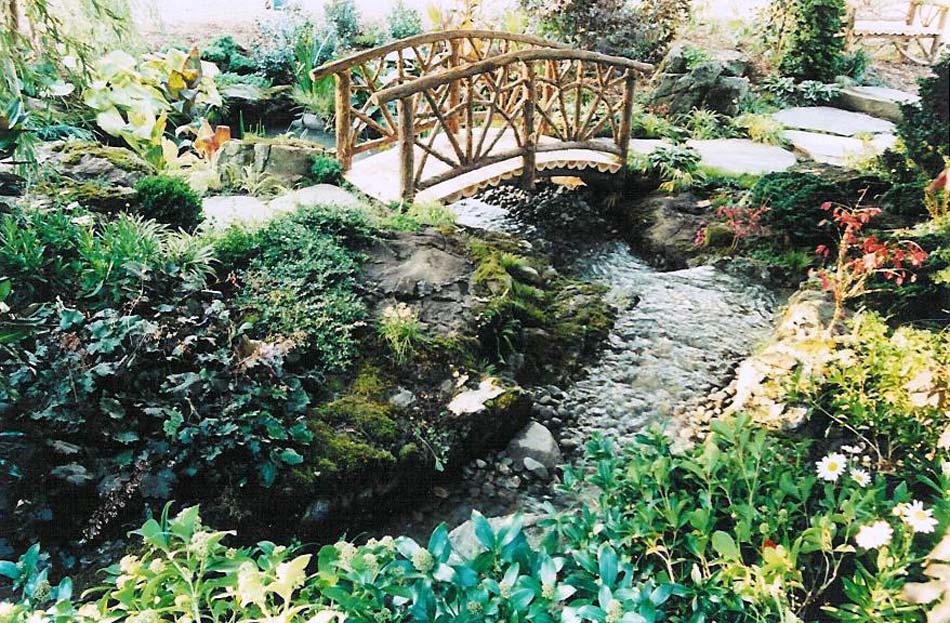 Natural wood bridge built with trees and branches at Nassau County Museum of Art