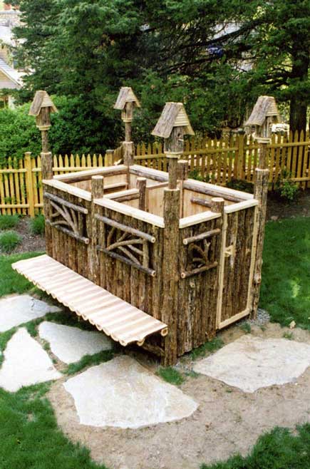 A one of a kind outdoor shower constructed with bark-on cedar trees and cedar deck boards