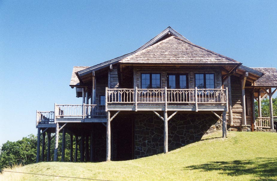 Natural wood deck railings built with trees and branches titled Arrow Deck Rails