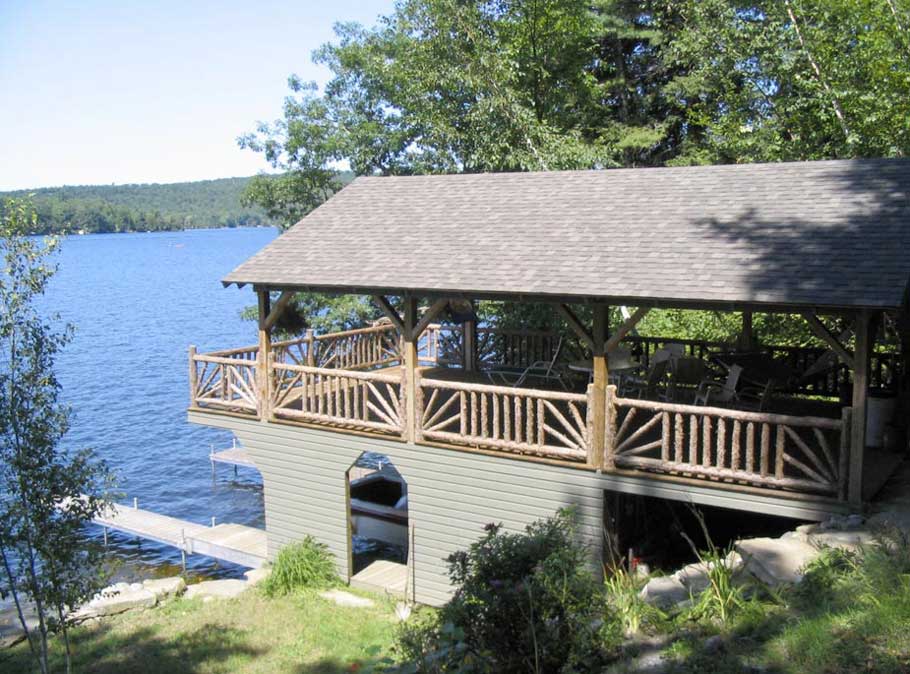 Rustic railings custom built using cedar trees and branches titled Boat House Rails