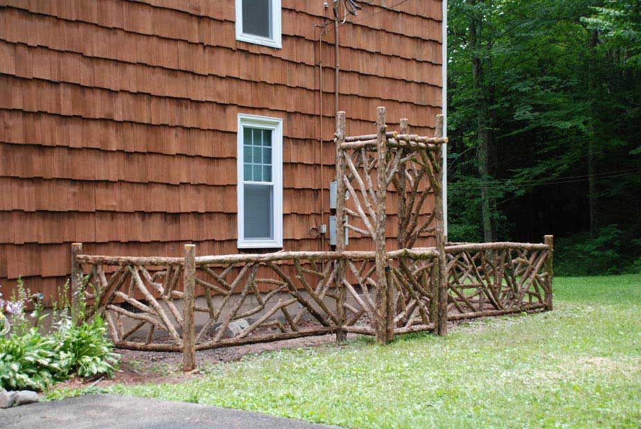 Rustic garden fencing custom built using cedar trees and branches titled Chichester Garden