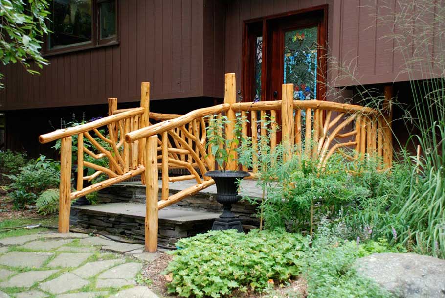 Natural wood porch railings built with trees and branches titled Gold Porch Rails