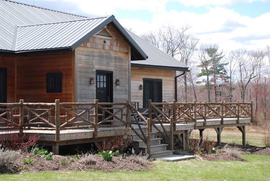 Natural wood railings built with trees and branches titled Huguenot Railings