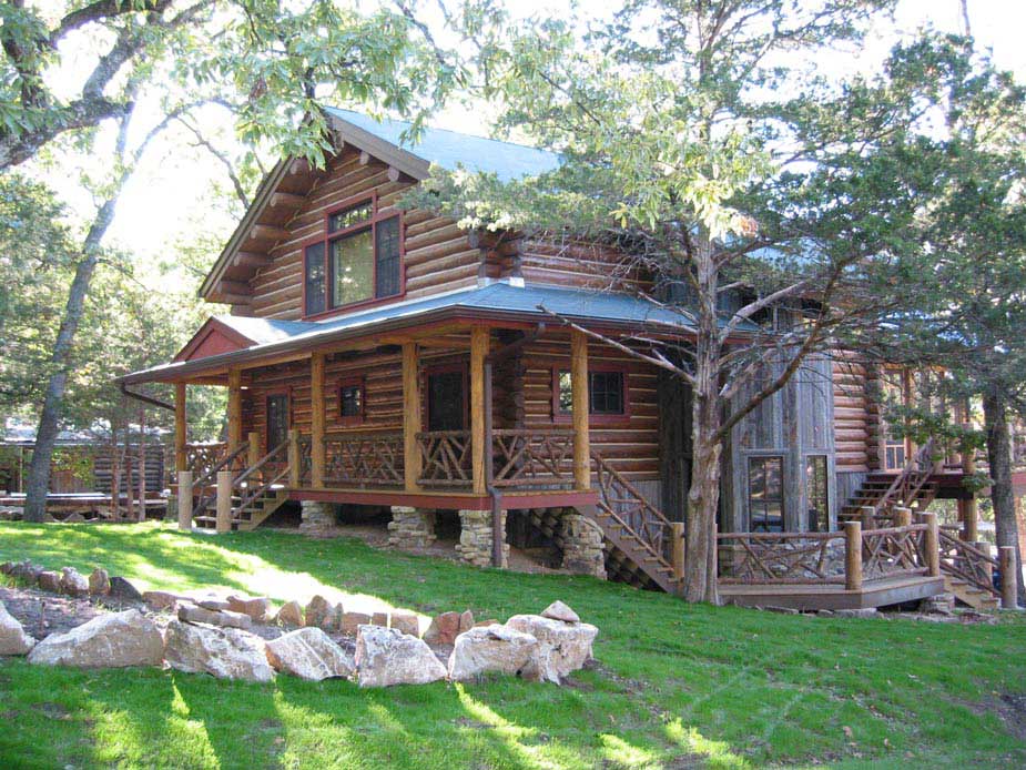 Rustic railings built using bark-on trees and branches titled Log Home Rails