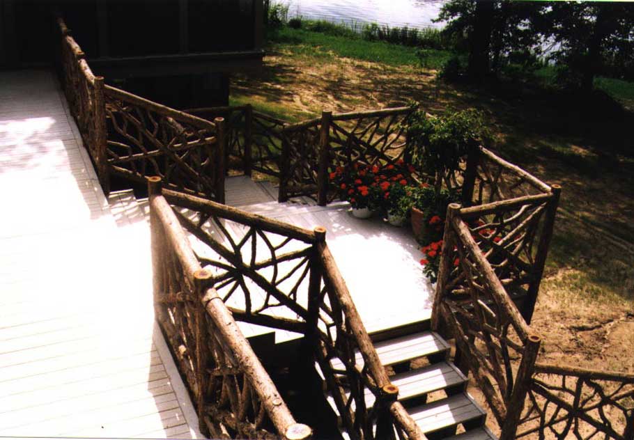 Natural wood deck railings built with trees and branches titled Remey Rails