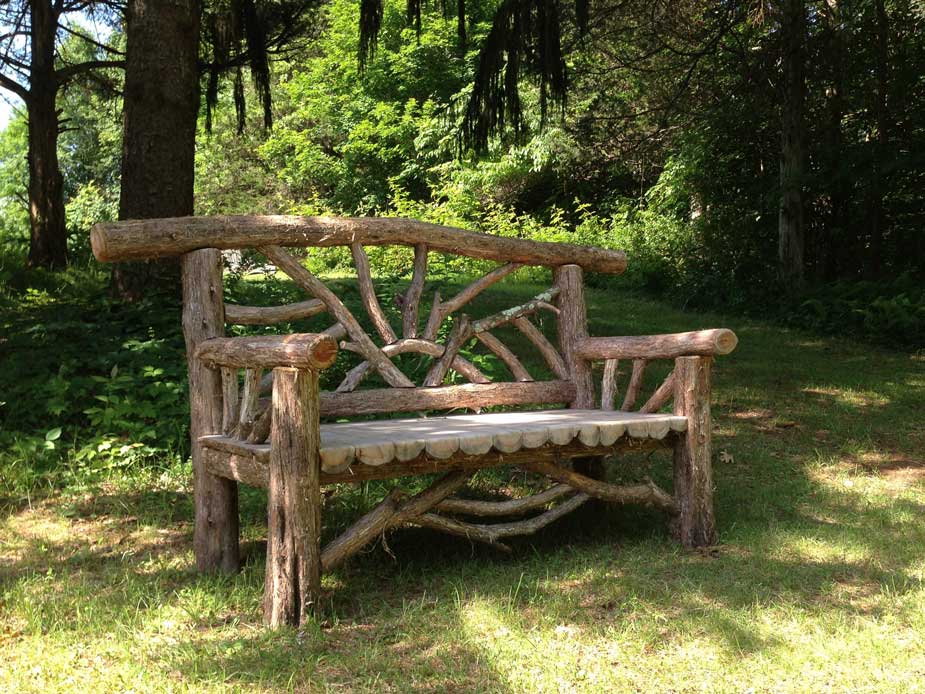 Outdoor rustic garden bench built using bark-on trees and branches titled the Catskill Butterfly