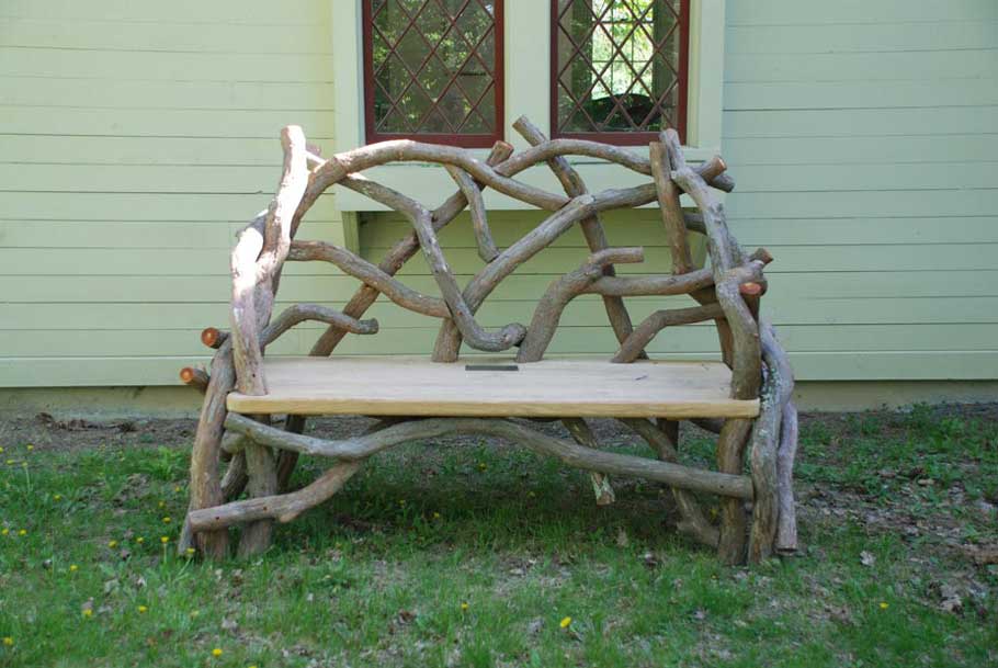 Outdoor rustic park bench built using mountain laurel trees and branches at Olana Historic Site