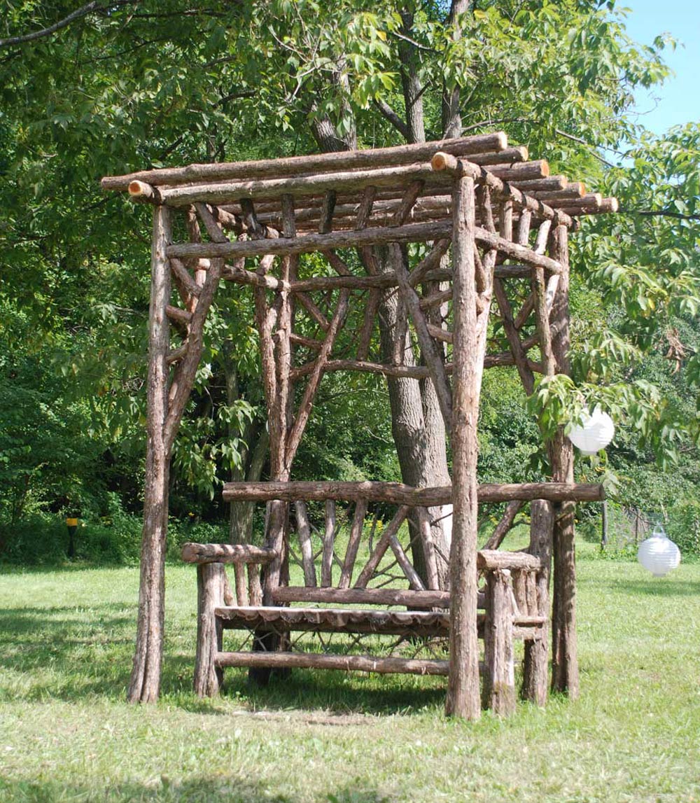 Rustic covered bench custom built using cedar trees and branches titled the Durham Shelter