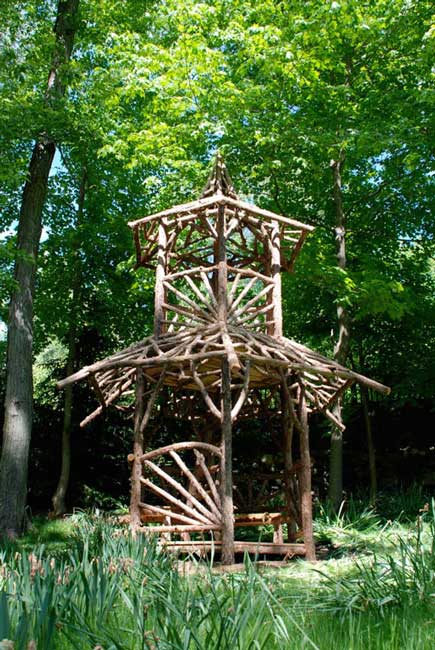 Outdoor rustic tree tower built using bark-on trees and branches titled the Kelly Tree Tower