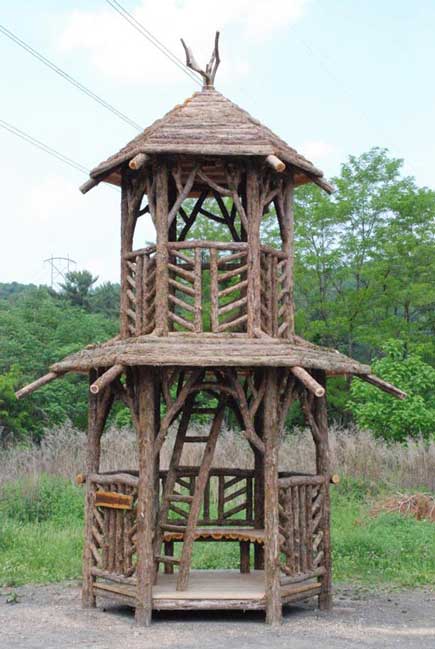 Outdoor rustic tree tower built using bark-on trees and branches constructed for the Strawbery Banke Museum
